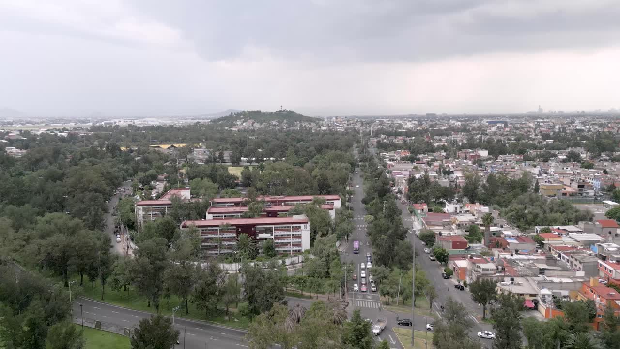 Forward Drone Aerial Motion Over City Traffic With Trees and Houses and Buildings in the Background in Mexico – Cloudy Day 4K