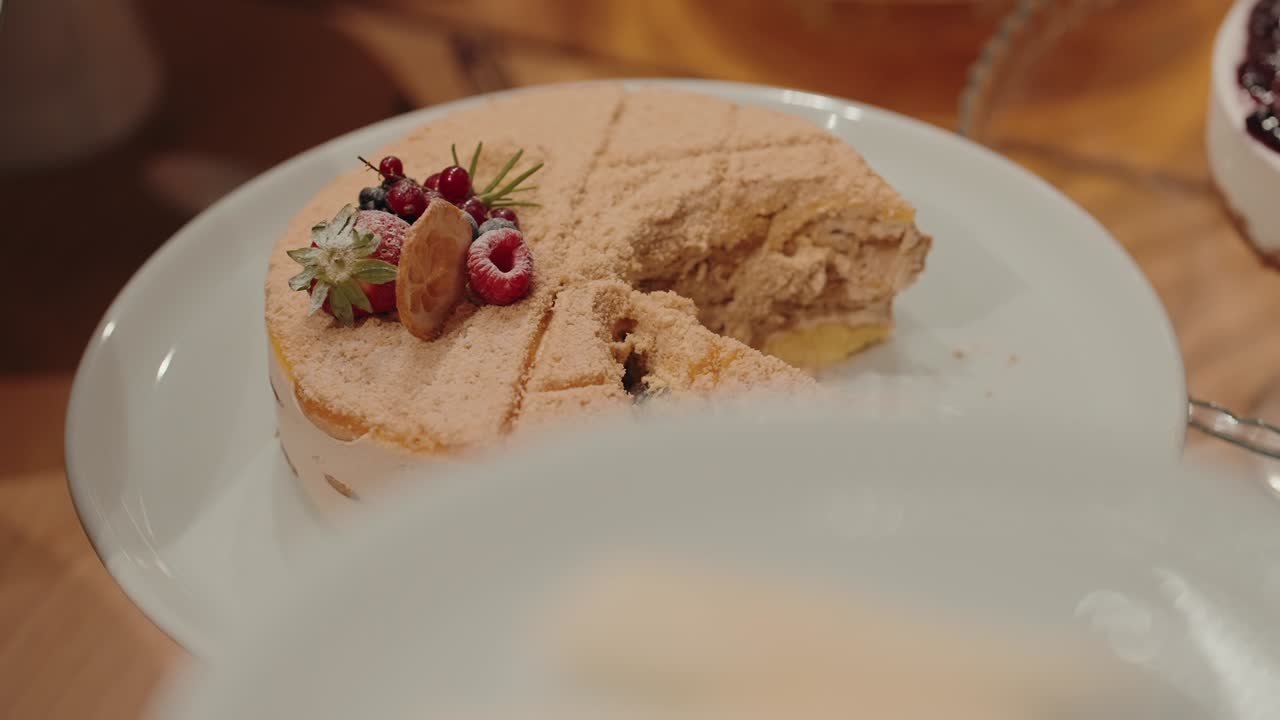 creamy layered cake sliced with fruit topping and cinnamon dust