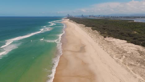 drone captures ocean waves and sandy beach