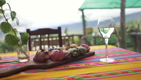 a glass of white wine accompanied by a board of empanadas