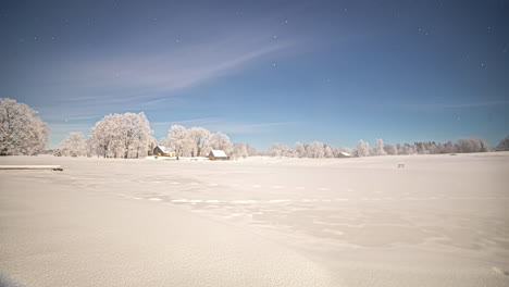 stars crossing the night sky over a cabin in a snowy winter countryside - time lapse