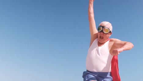 elderly man jumping and dressing like a superhero