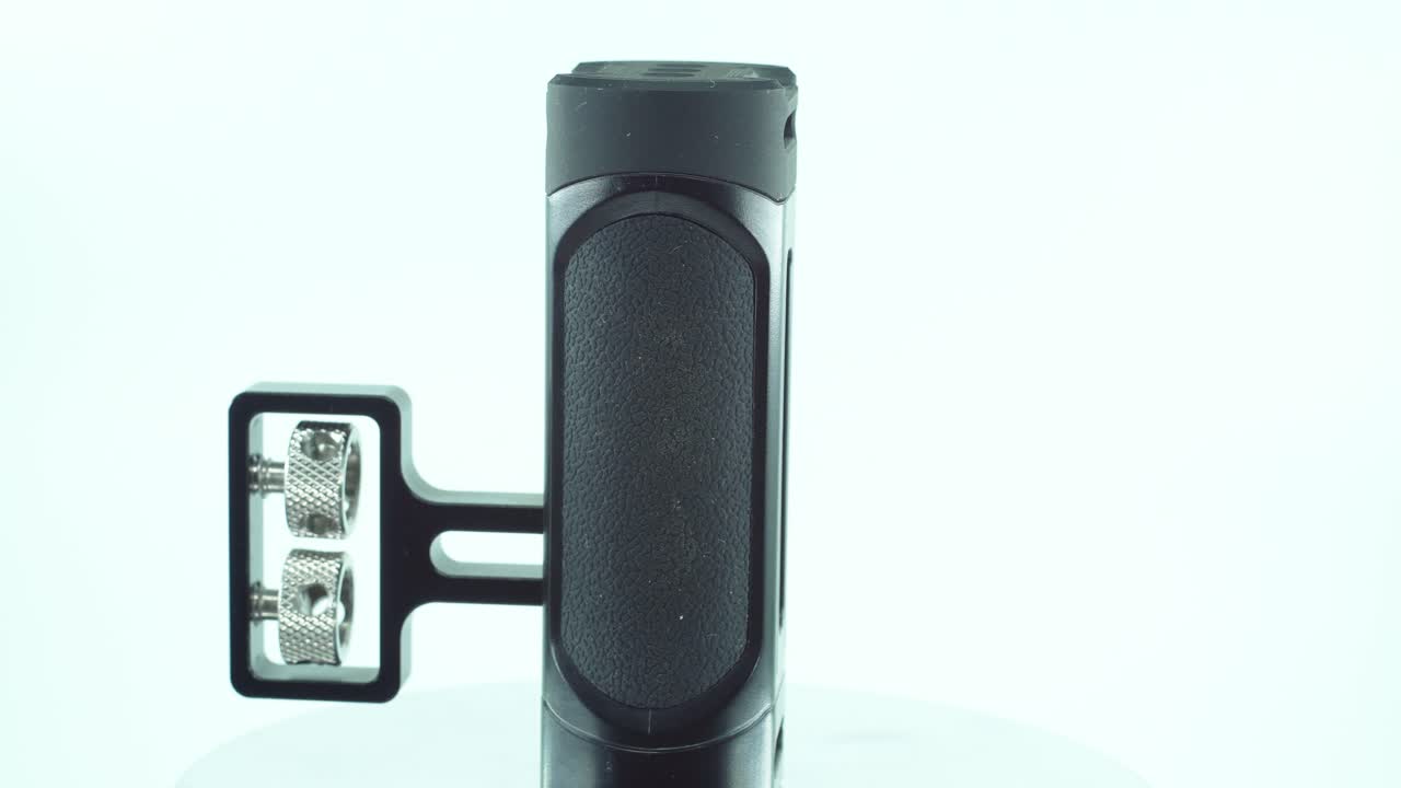 un primer plano de un controlador de cámara de metal negro, equipo de producción de video, en un soporte giratorio de 360, iluminación de estudio, cámara lenta, 4k
