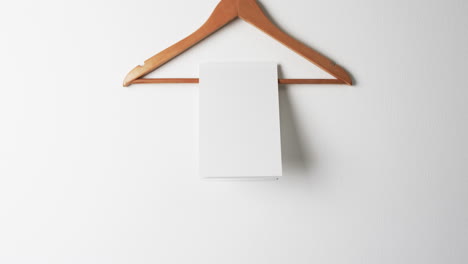 video of book on hanger with white blank pages and copy space on white background