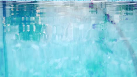 water reflection of mother and son walk on swimming pool side