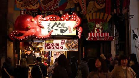 crowd gathered at a vibrant takoyaki stand