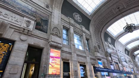 interior of milan train station with digital displays