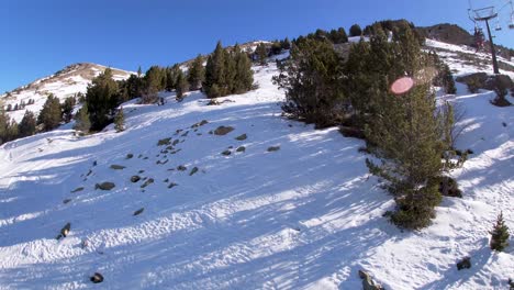 Going-up-on-snowboard-chairlift-cable-car-in-Pyrenee-mountain-resort-during-a-sunny-day