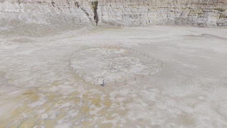 aerial drone footage of a woman walking in the crater of an active volcano in nisyros, greece. d-log m profile