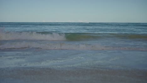 waves coming into the shores of the beach