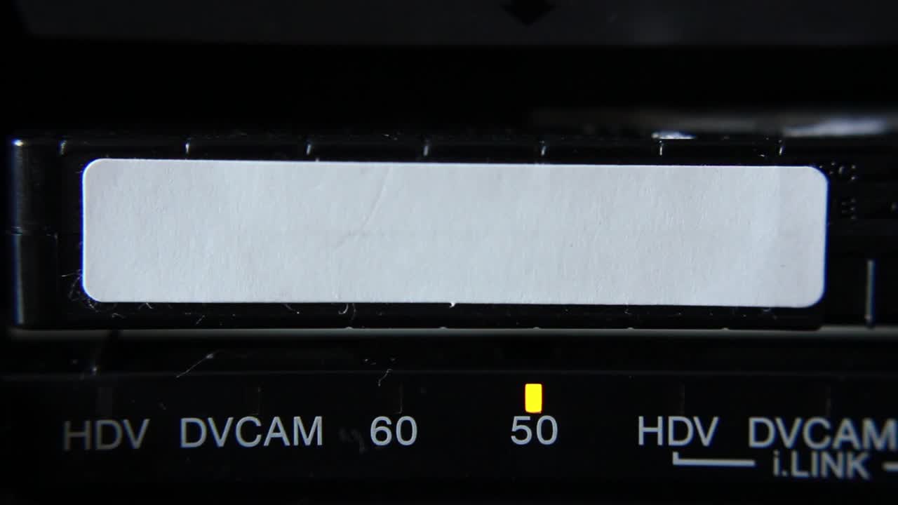Close-up of DVCAM Video Tape Being Inserted into a Recorder