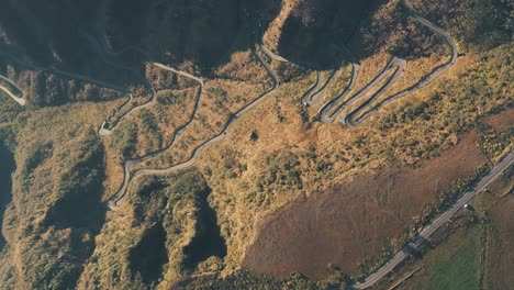 top down aerial view of sierra tropical rainforest road, serra do rio do rastro and the mountains of santa catarina at sunrise