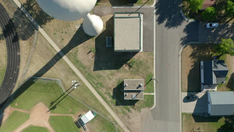 aerial top-down view of water tower and treatment facility in north american rural town