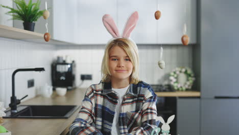 child in easter bunny ears in kitchen