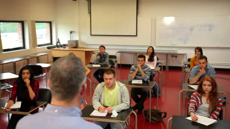 estudiantes escuchando atentamente a su maestro en clase