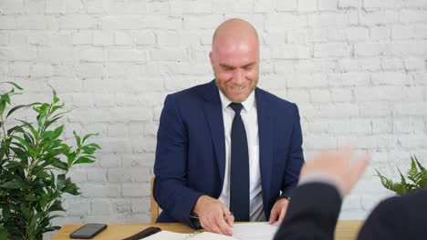 Handsome-Confident-Entrepreneur-Businessman-Talking-and-Laughing-At-Office-Meeting