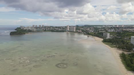 drone flying over downtown tumon and tamuning on the tropical island of guam