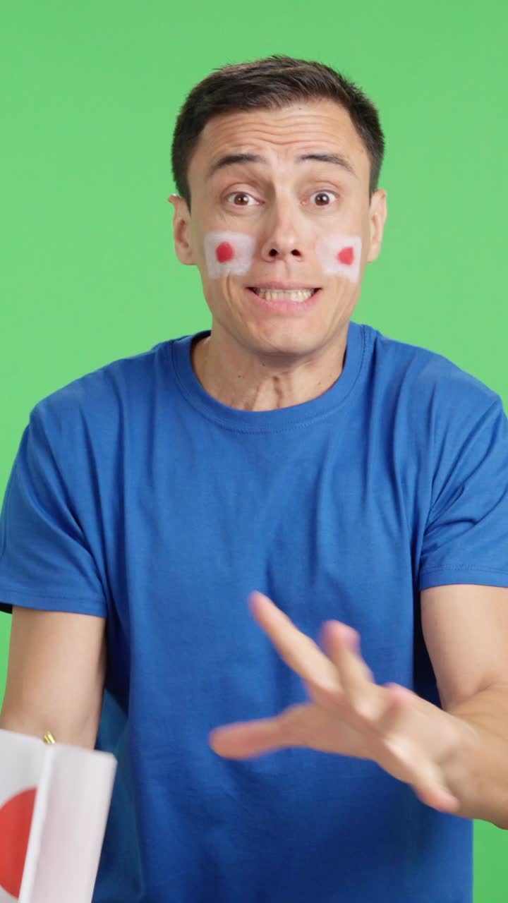 Man cheering for Japan during a match that is lost