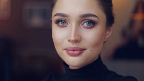 portrait of young female in black shirt posing sensually and looking at camera