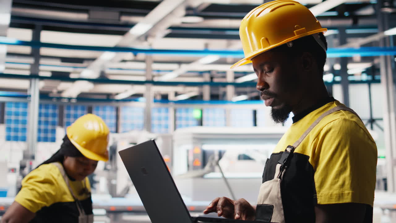 Vertical Video Male engineer in solar panel factory reviews photovoltaic system performance