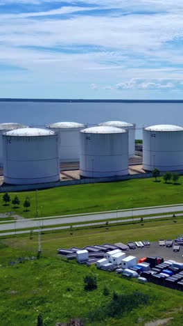 large industrial tanks near a coastal area on a sunny day