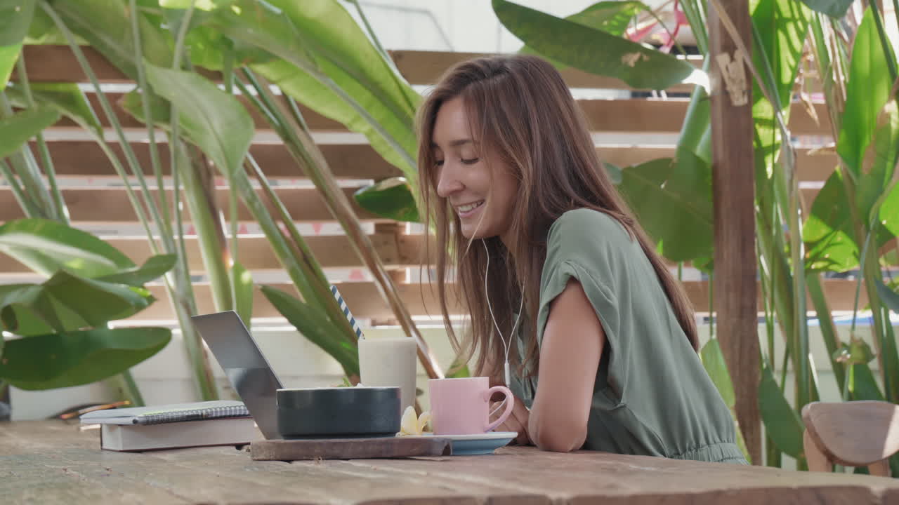 Woman Working at Breakfast in Cafe