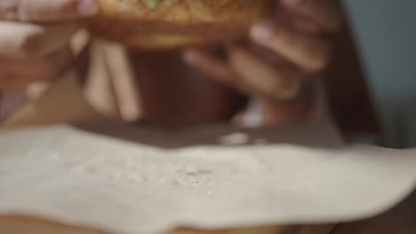 person eating a bagel sandwich