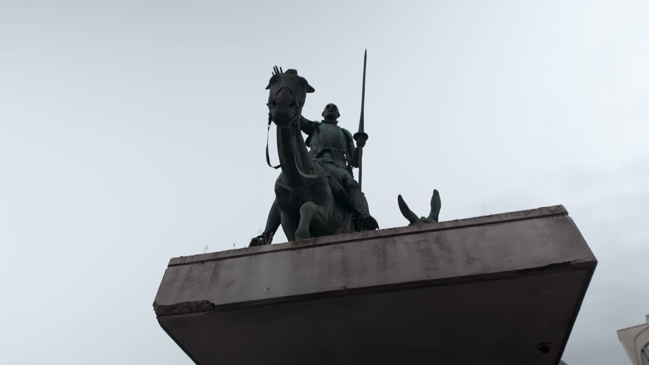 Low-angle view of the bronze monument depicting Don Quixote and Sancho Panza on the Place d'Espagne in Brussels, Belgium