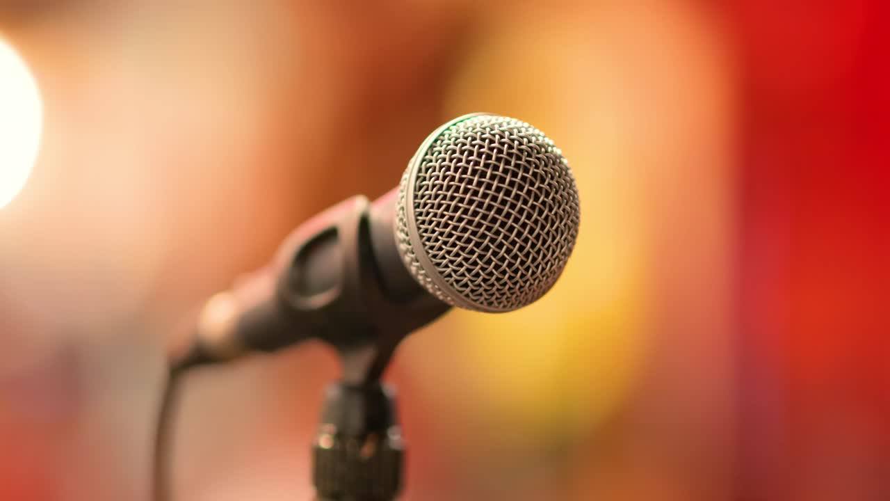 Microphone on stage against a background of auditorium.