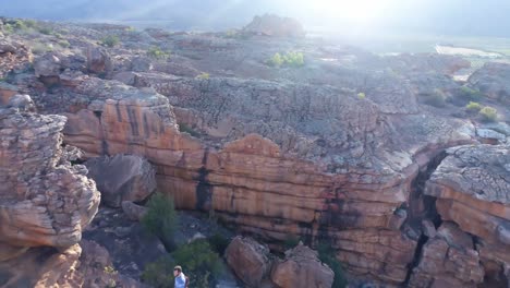 male rock climber standing over a rocky mountain 4k