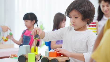 preschool children playing with wooden toys