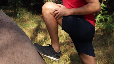 man warming up using a rock on the field close up