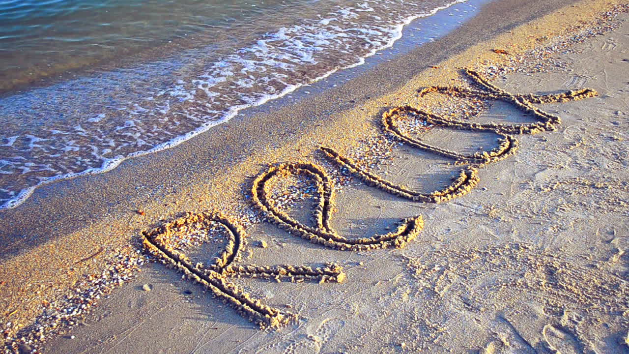 Inscription a relax on sand. Inscription on sand, the beach