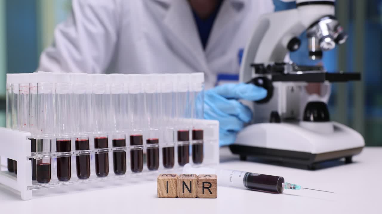 Lab Technician Performs Blood Tests with Test Tubes, Syringe, and Microscope