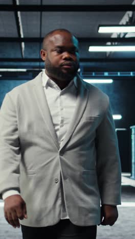vertical video employee walking in data center with blinking lights on rigs