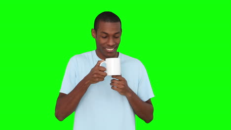 Casual-young-man-enjoying-cup-of-coffee