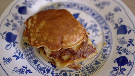 anonymous person eating tasty pancakes