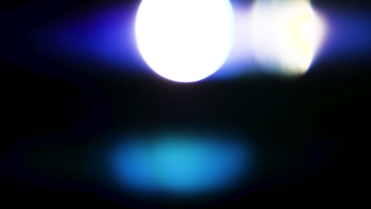 Beautiful, stunning light reflections and anamorphic blue streaks shot on black with high-end cinema anamorphic lens as a background, light leak overlays or transitions for editors