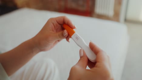 woman taking a pregnancy test