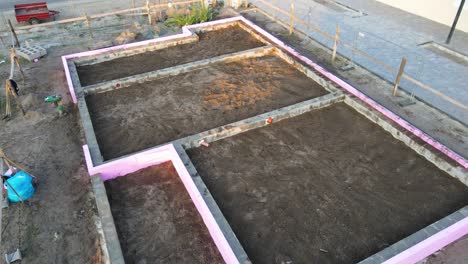 house foundation in drone view during construction with pipes and insulation