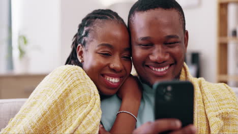 Relax,-phone-and-black-couple-on-sofa-in-home