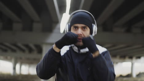 man boxing workout under an overpass