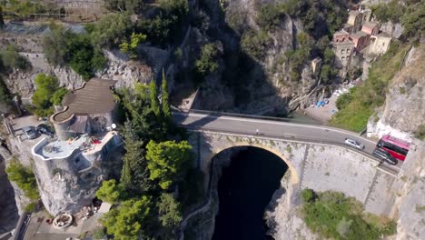 Fiordo-di-Furore-bridge-on-Amalfi-coast,-aerial-drone-rising-reveal