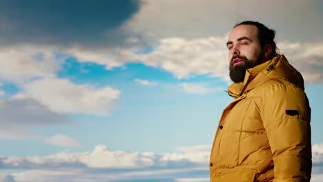 adventure seeker gazes at the valley and mountain peaks ahead