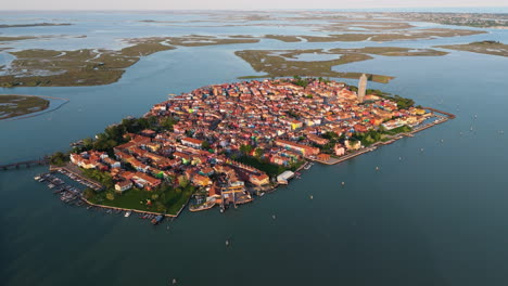 scenic view of burano island in the venetian lagoon at sunset in italy - drone shot
