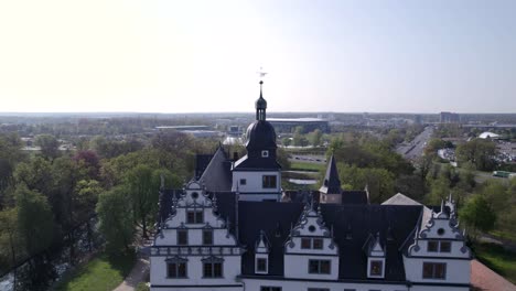 zoom out from clock tower to whole castle and surroundings in wolfsburg