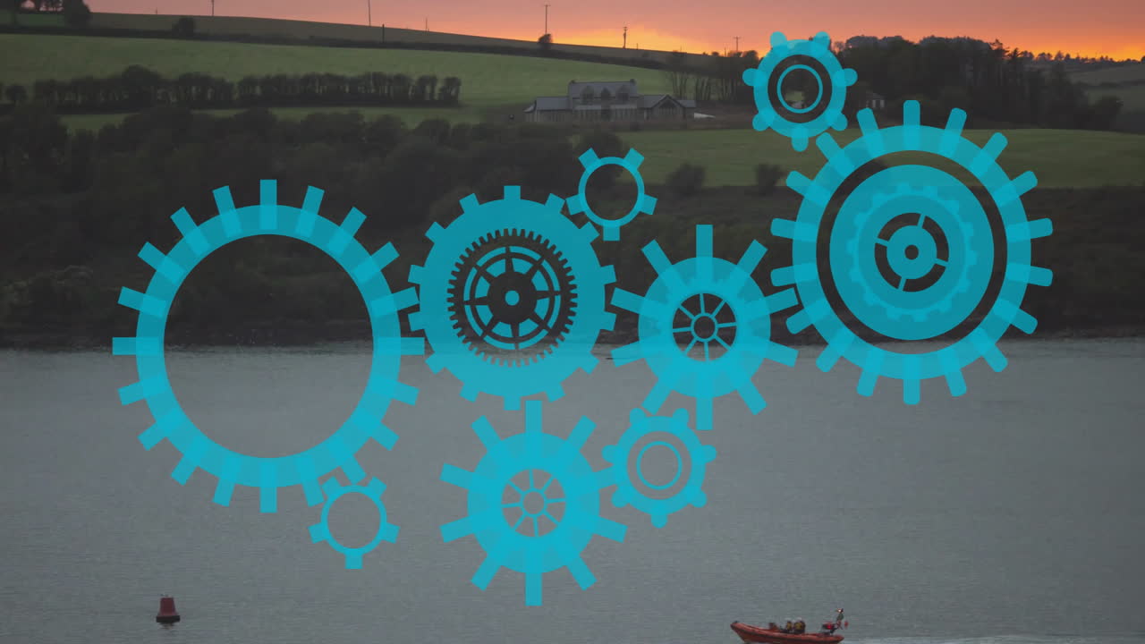 Blue gears animation over boat on lake with sunset in background