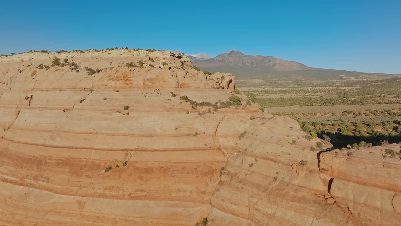 Aerial view of Moab's red rock cliffs under clear blue sky