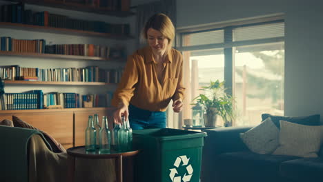 Woman recycling glass bottles at home