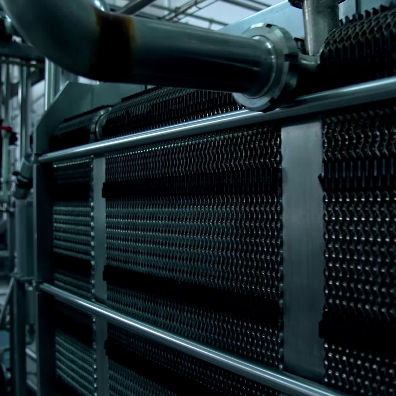 Interior of modern plant. Milk production factory with special automated equipment. Metal industrial appliances for food processing on dairy farm